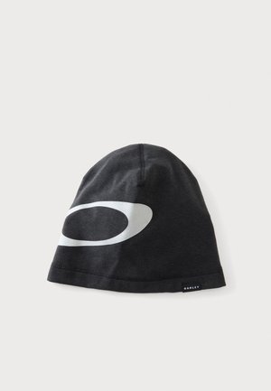 Black Oakley beanie hat with large white oval logo and small Oakley tag on plain light background.