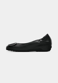 Black leather ballet flat with rounded toe, featuring a decorative black accent on the front, and flexible rubber sole.