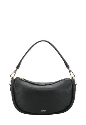 Sac à bandoulière en cuir noir avec une forme arrondie, doté d'une poignée courte, de quincaillerie dorée et d'une fermeture éclair. Nom de la marque affiché.