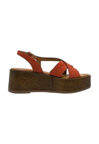 Sandale en suède rouge avec un design croisé large, une sangle réglable et une plateforme marron texturée avec un motif en grille.