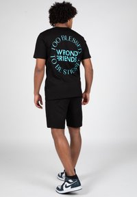 Wrong Friends SAFI - Tracksuit bottoms - black