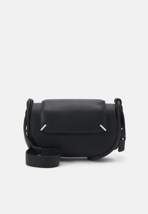 Black leather shoulder bag with a rounded shape, front flap, and silver accent details. Features an adjustable strap for versatility.