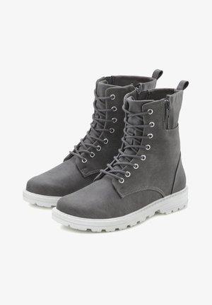 Gray canvas ankle boots with round toe, lace-up front, and zip on the side. Rubber sole with textured tread and reinforced heel accents.