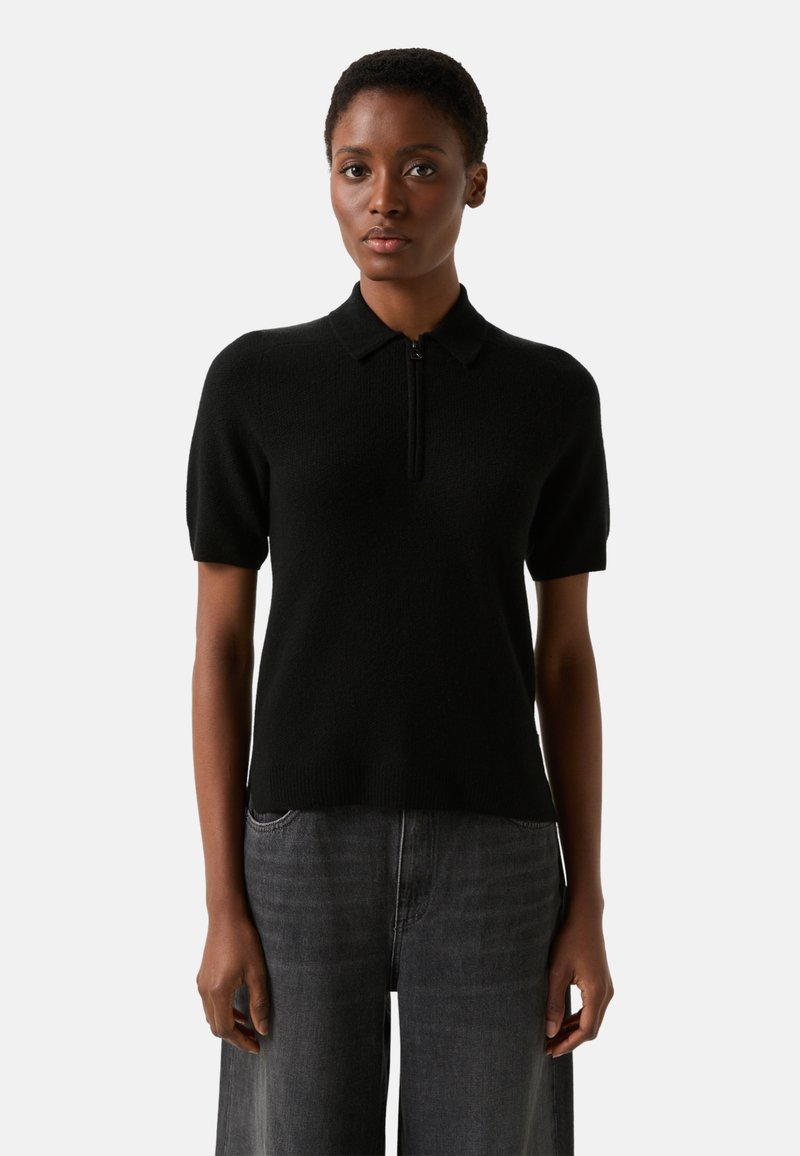 Black short-sleeve polo sweater made of soft material, featuring a zippered front, a classic collar, and a fitted silhouette.
