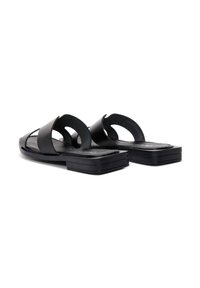 Schwarze Lederflip-Flops mit offenem Design, ausgestattet mit zwei breiten Riemen und einer flachen, rechteckigen Sohle für Komfort und Stabilität.