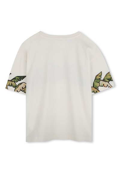 T-shirt à manches courtes en coton crème avec un motif de feuilles de palmier vertes et beiges sur les manches. Coupe décontractée et col rond. Texture lisse.