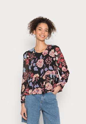 Blusa preta com padrão floral e mangas longas, apresentando um design peplum e padrões de flores rosas e azuis sobre um fundo escuro.