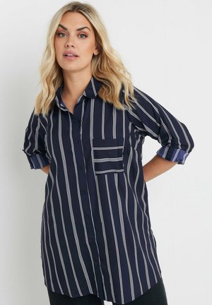 Navy button-up shirt with white vertical stripes, short rolled sleeves, and a chest pocket. Smooth fabric with a relaxed fit.