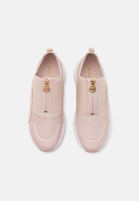 Pink slip-on shoes with a smooth upper, mesh toe area, and a gold zipper accent. White rubber sole and logo embossed on the side.