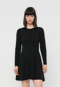 Black long-sleeve dress with a flared skirt, made from a smooth fabric. Features a round neckline and a fitted bodice.