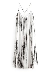 Vestido sin mangas en blanco y negro con corte recto, que presenta patrones de rayas verticales, tirantes delgados y una textura ligera y sedosa.