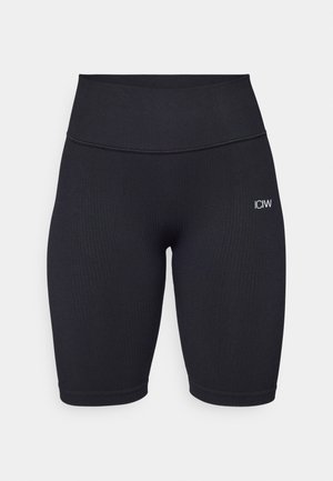 Sorte ribbede sykkelshorts med høy midje og logoen "ICIW" i hvitt på låret. Stoffet ser mykt og elastisk ut for komfort.