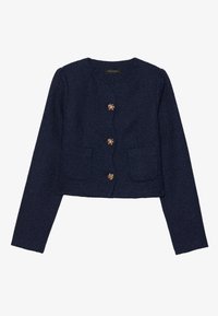 Veste cropped bleu marine en tissu texturé, avec un col rond, des manches longues et six boutons décoratifs en ton doré.
