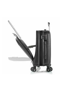 Black hard-shell suitcase with a textured surface, retractable handle, and four wheels. Lid partially open, revealing interior straps for securing items.