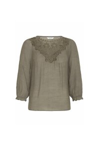 Blusa verde oliva, dal taglio ampio, con delicate ricami floreali intorno al collo. Maniche lunghe con polsini arricciati e texture morbida.