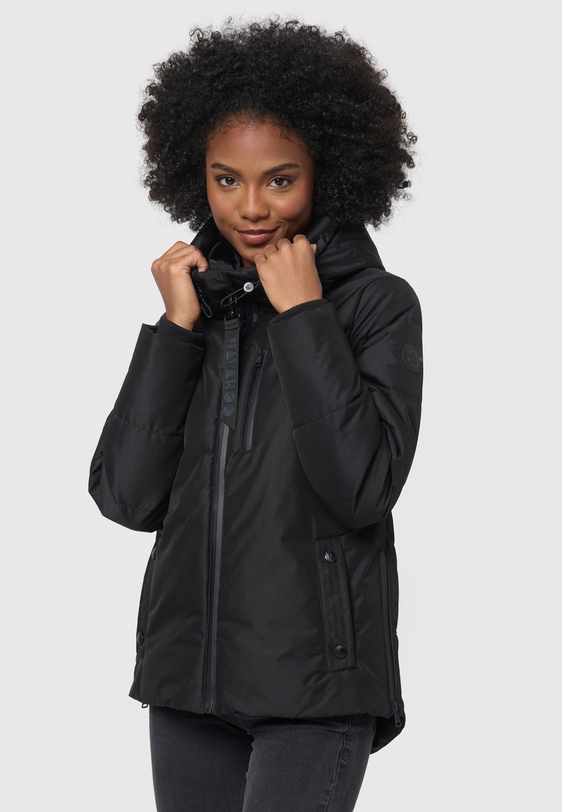 Black puffer jacket with a high collar, front zip, and side pockets. Features textured fabric and toggles for adjustment. Sleek, insulated design.