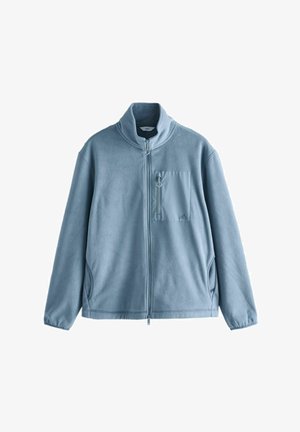 Sky blue fleece jacket with a high collar, full zip, and a chest pocket featuring a zip closure. Soft texture and relaxed fit.