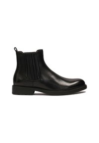 Botas de piel negra hasta el tobillo con una superficie lisa, paneles laterales elásticos, punta redondeada y un tacón bajo de goma para mayor tracción.