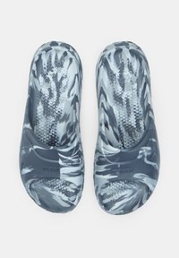 Szürke és fehér slip-on szandálok, melyek texturált, mintás felsőrésze tigristipeszerű. Integrált talpbetét, lekerekített kiemelkedésekkel a tapadás érdekében.