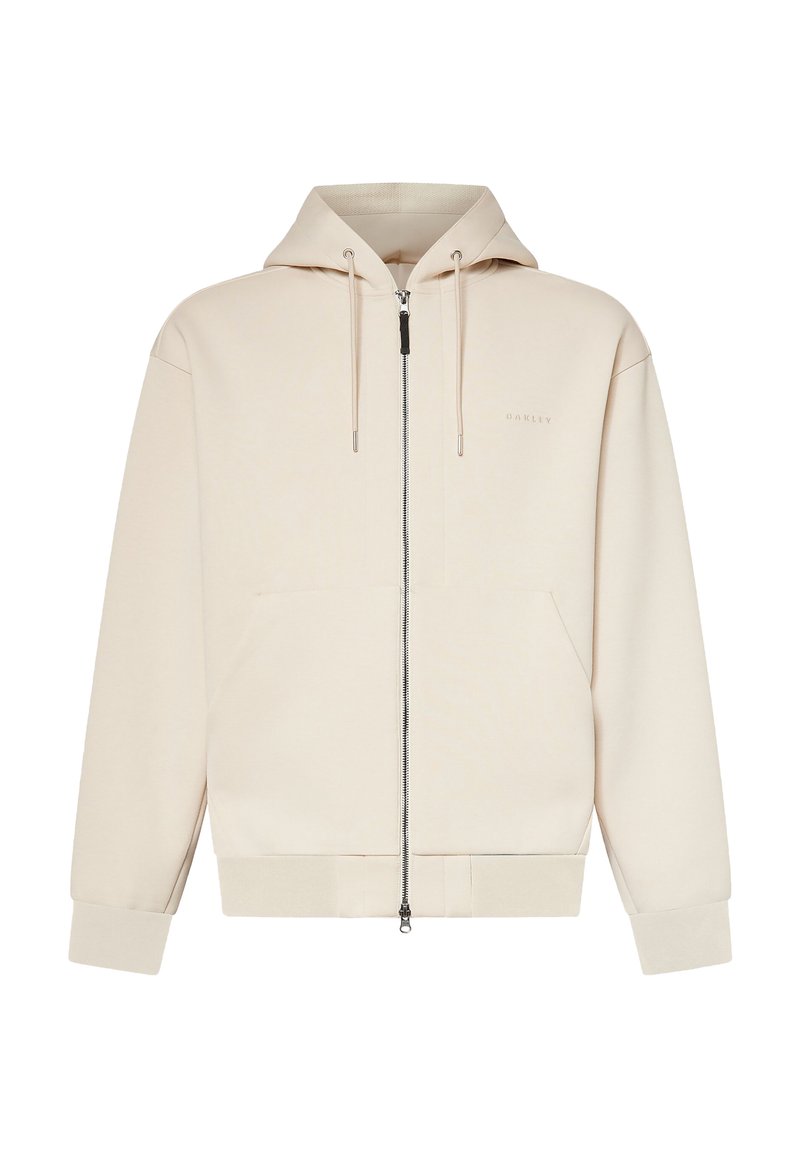 Sweat à capuche beige zippé intégralement, capuche à cordon, manches longues, poches avant et logo discret "Oakley" sur la poitrine gauche.