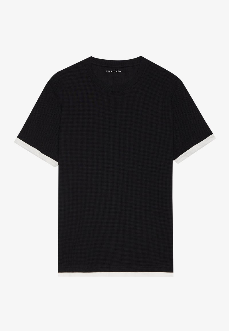 T-shirt noir avec une finition texturée, présentant des accents blancs sur les bords des manches et un design classique à col rond.