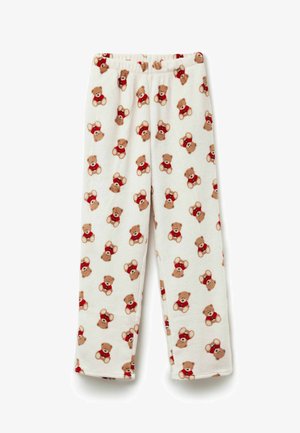 Spodnie piżamowe z polaru z elastycznym pasem, z wzorem misiów w czerwonych koszulkach na kremowym tle. Miękka tekstura.