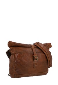 Brūna ādas sūtījumu soma ar rullējošo augšdaļu, regulējamu plecu siksnu un metāla sprādzi. Tekstūrēta virsma, mīksts izskats.