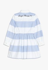 Pruhované šaty s modro-bílými horizontálními pruhy, límcem na knoflíky a staženým pasem. Obsahují vyšívaný text "League Champs '67."