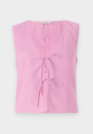 Pink linen sleeveless top with a V-neck and adjustable tie closure. Features a relaxed fit and smooth texture. Label visible at the neckline.