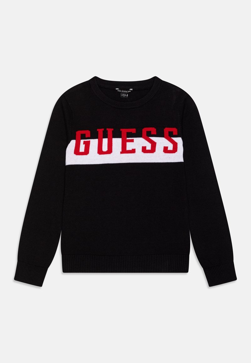 Pull noir à manches longues avec une bande horizontale blanche sur la poitrine et un lettrage rouge vif « GUESS » centré à l'avant.