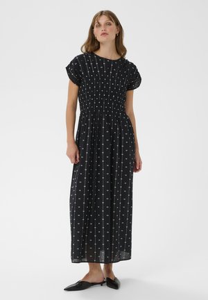 Fekete maxi ruha rövid puffos ujjakkal, fehér pöttyös mintázattal és smockolt részletekkel a mellrészen. Sima anyag, lágy eséssel.
