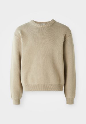 Beige knit sweater with a round neckline, long sleeves, and ribbed cuffs and hem. Features a textured pattern throughout the fabric.