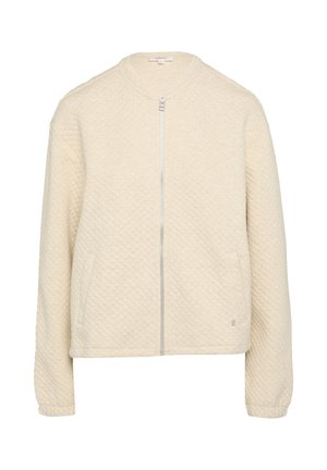 Veste bomber en crème matelassée avec un col rond, fermeture éclair sur toute la longueur et poches latérales. Texture douce avec un design minimaliste.