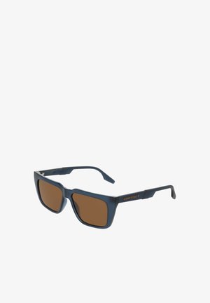 Niebieskie plastikowe okulary przeciwsłoneczne z brązowymi soczewkami, kwadratowym kształtem i subtelnym logo na zausznikach. Rękojeści mają teksturowany wzór.