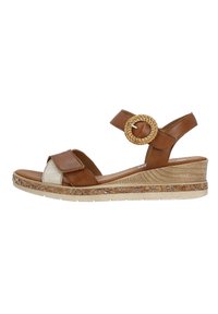 Sandale compensée en cuir marron avec une sangle en tissu texturé, un accent en tissage circulaire et une semelle à motifs. Sangle ajustable pour un maintien sécurisé.