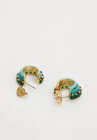 Gold-tone hoop earrings featuring turquoise accents and green gemstones. Detailed with a heart-shaped charm and a textured surface.