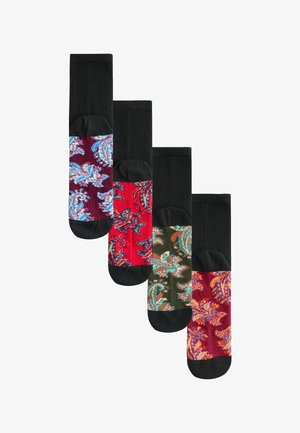 Vier Paar knielanger Socken mit schwarzen Bündchen und bunten Paisley-Mustern in Rot, Grün und Burgunder auf dem Fußteil.