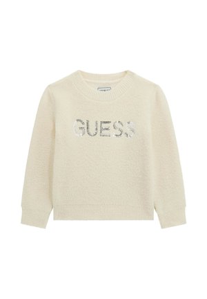 Maglione color crema con una consistenza soffice, caratterizzato da un logo "GUESS" in paillettes argentate sul petto e polsini e scollatura a coste.