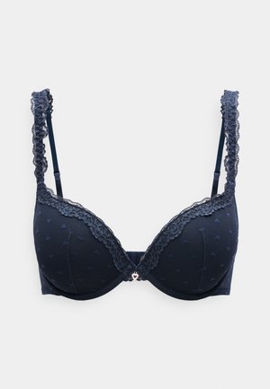 Marineblå bh med polstrede kopper, blonder på stropper og kopper, hjerteformet detalj i midten, og små hjerte-mønstre på stoffet.