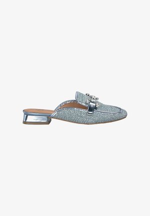 Light blue woven slip-on shoe with a metallic silver heel, featuring decorative hardware on the upper and a rounded toe design.