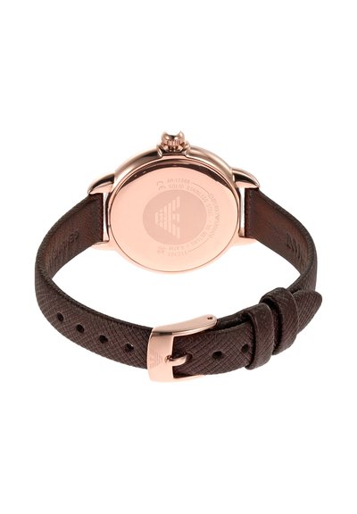 Brun läderarmband med en texturerad yta, klockhus i roséguld av rostfritt stål, rund form och en krona på sidan.