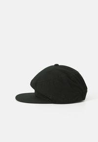 Black cap made of fabric, featuring a curved brim, rounded crown, and two ventilation eyelets on each side. Simple and unadorned design.