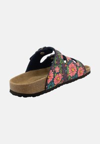 Sandale à glissière florale avec un motif de fleurs multicolores sur une tige en tissu, semelle en liège et semelle extérieure en caoutchouc noir. Présente des découpes et des accents métalliques.