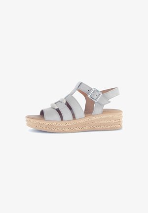 Light gray leather sandals with multiple straps, adjustable buckle, and a textured platform sole in a natural color.