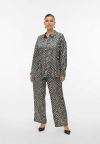 Printed blouse and wide-leg pants set in a silky fabric featuring a beige and navy zigzag pattern, with a relaxed fit and collar detail.