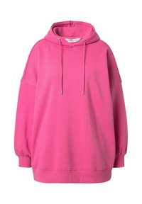 Jasnoróżowy, oversize'owy hoodie związywany na sznurki, z prążkowanymi mankietami i dołem, wyeksponowany na białym tle.