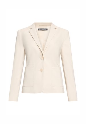 Blazer sur mesure de couleur crème, à deux boutons, col à revers cranté, manches longues, et deux poches plaquées à l'avant.