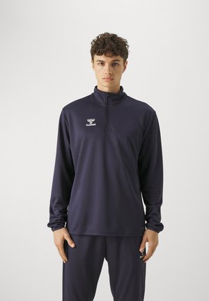 Marinefarbener, Reißverschluss-Sportpullover mit langen Ärmeln, aus glattem, dehnbarem Material gefertigt. Verfügt über ein kleines weißes Logo auf der Brust.