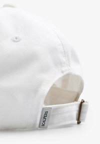 Witte katoenen baseballcap met een gebogen vizier, verstelbare band met een metalen sluiting en een klein merklabel aan de zijkant.