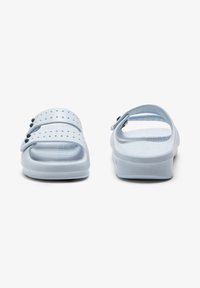 Light blue sandals with a thick, textured sole, dual straps, and side perforations for ventilation. Adjustable heel strap for secure fit.
